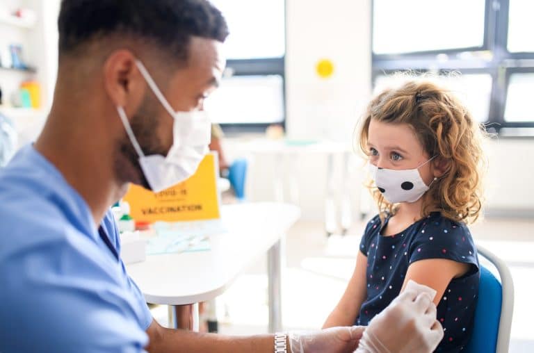 A child gets a vaccine from a medical provider.