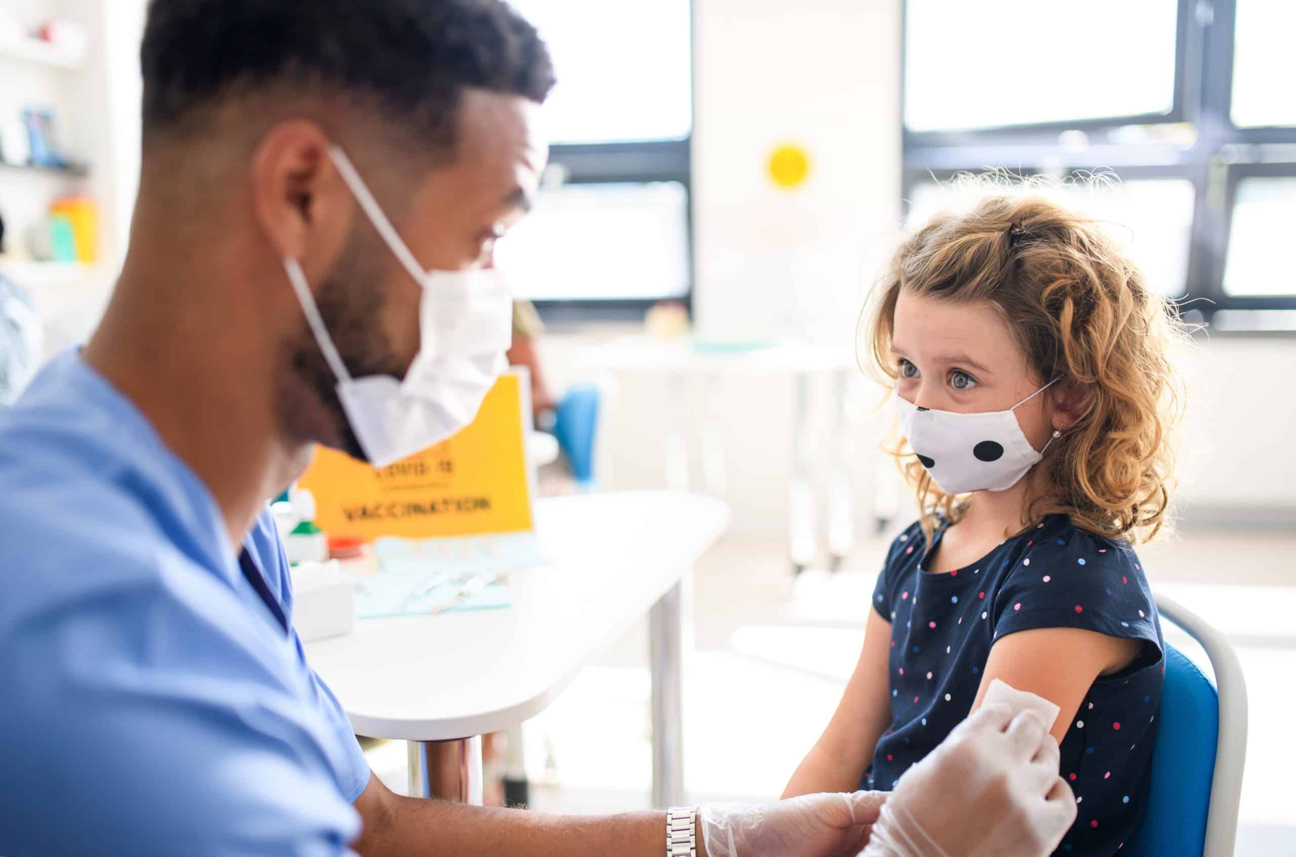 A child gets a vaccine from a medical provider.